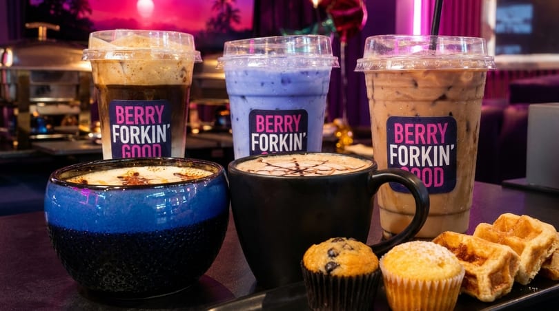 Berry Forkin' Good iced coffees, hot drinks, muffins, and waffles on a table.